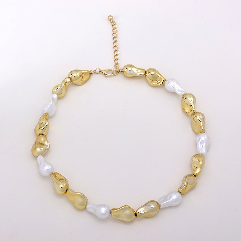 Gold and white irregular pearl necklace with lobster clasp and adjustable chain on white background