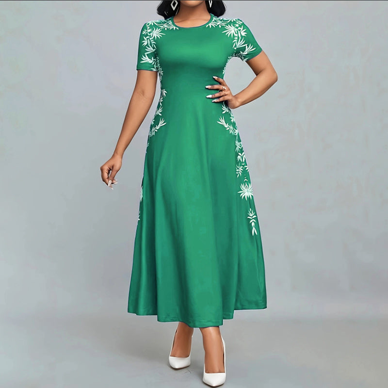 Woman wearing green short-sleeve maxi dress with white floral embroidery and white heels