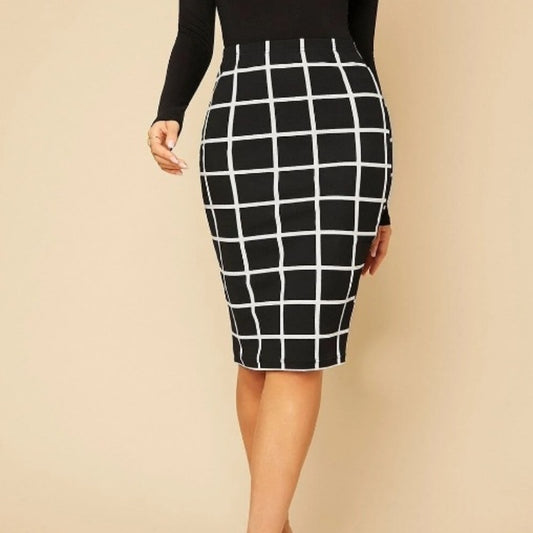 Woman wearing black and white checkered pencil skirt and black long sleeve top against beige background