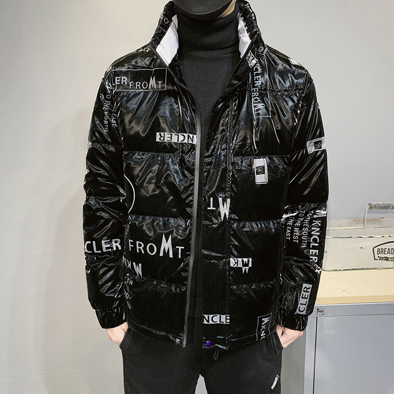 Black shiny puffer jacket with white text patterns, worn over a black turtleneck indoors