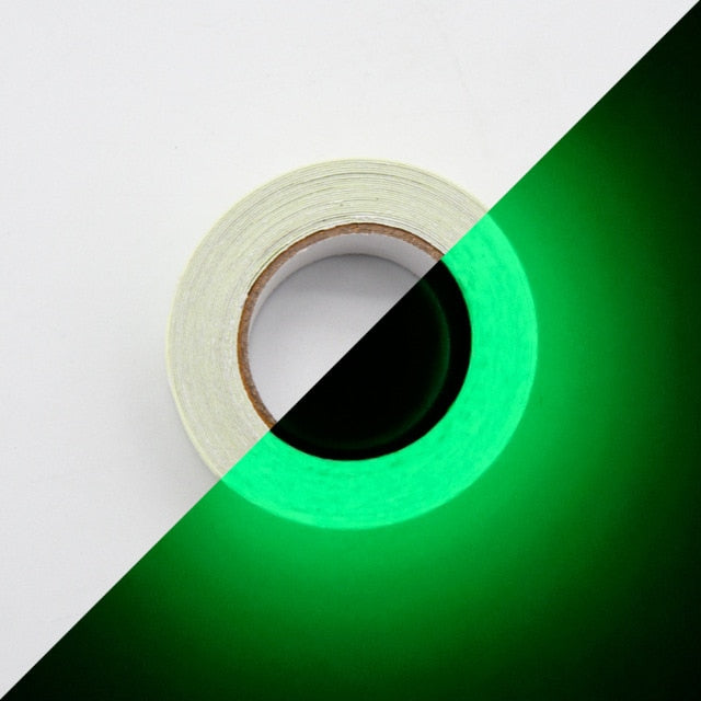 Roll of white tape shown in normal light and glowing green in dark, demonstrating glow in the dark tape