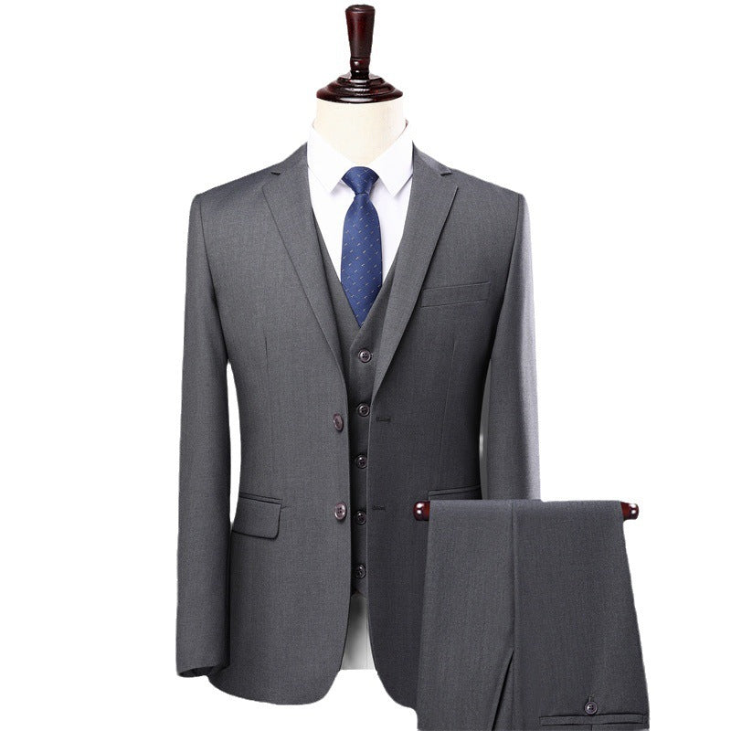 Men's grey three-piece suit with blue tie on mannequin with matching trousers