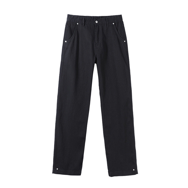 Black straight-leg pants with silver rivet details, front pockets, and a button closure
