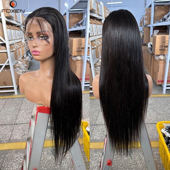 Long straight black wig displayed on mannequin head in warehouse with shelves and boxes