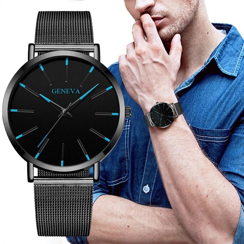 Black Geneva men's watch with blue luminous markers and stainless steel mesh band worn on wrist