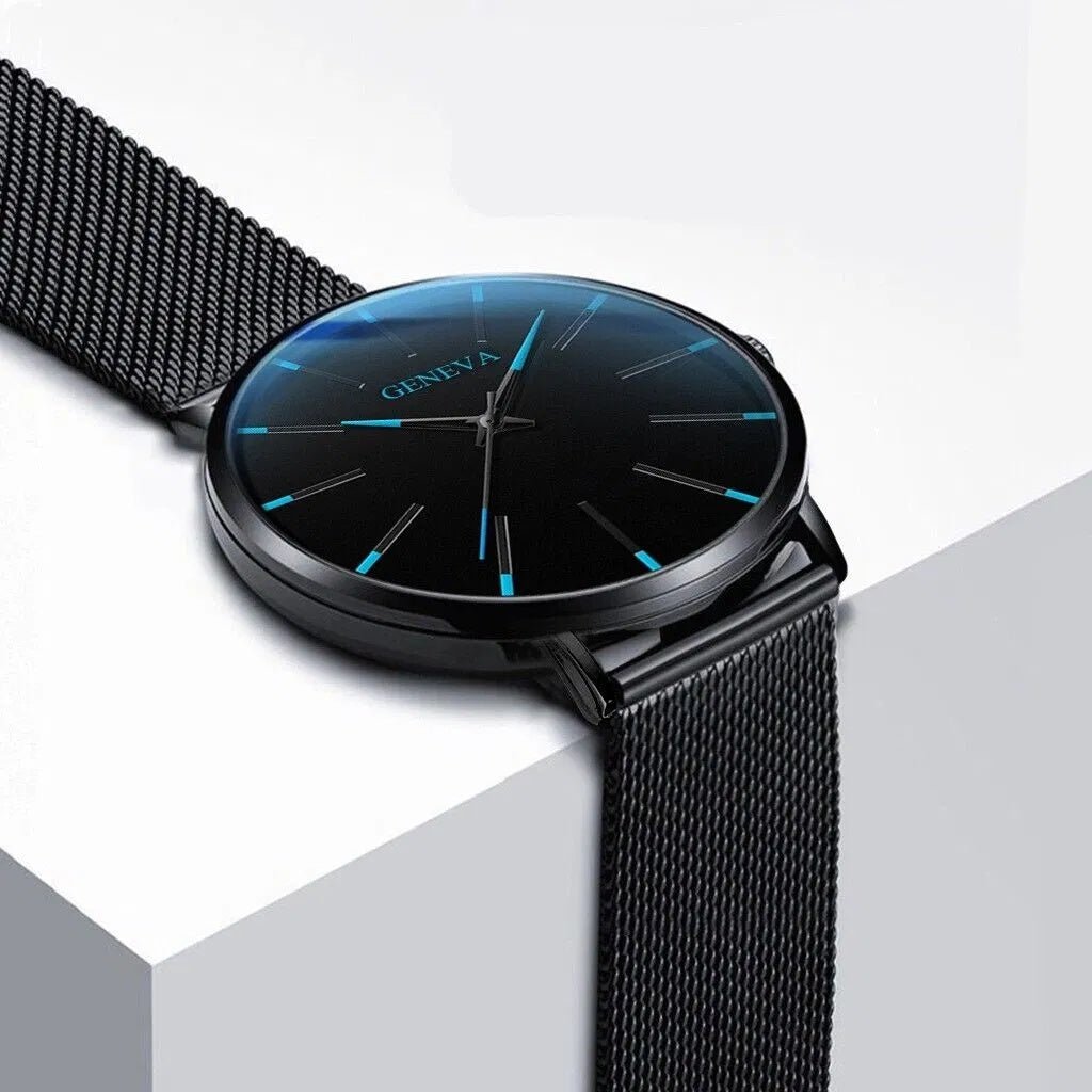 Close-up of a black Geneva men's quartz watch with luminous blue markers and stainless steel mesh band