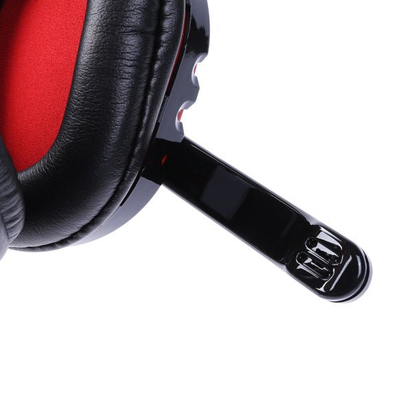 Close-up of black wireless Bluetooth headphones with red ear cushions and adjustable microphone