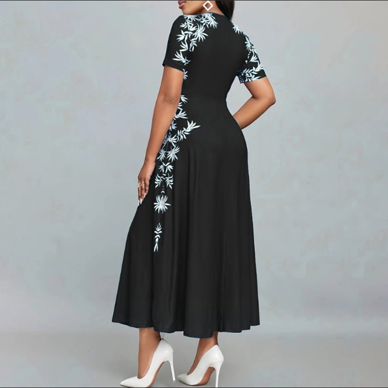 Woman wearing black short sleeve maxi dress with white floral embroidery and white high heels