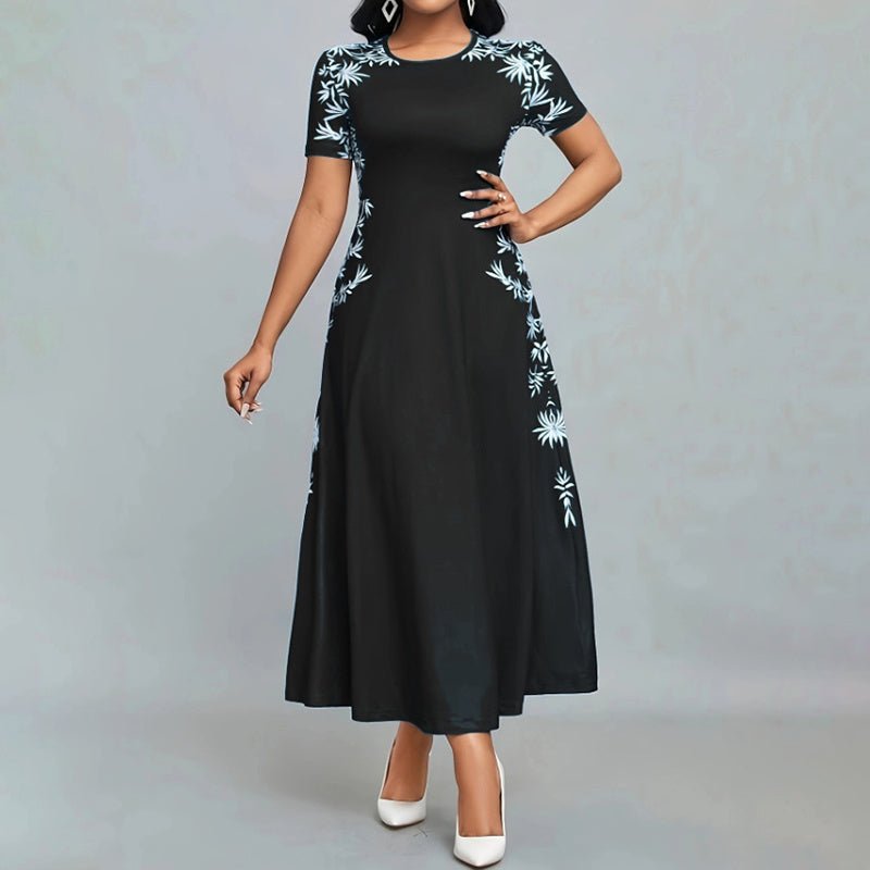 Woman wearing elegant black short sleeve maxi dress with light blue floral embroidery and white heels