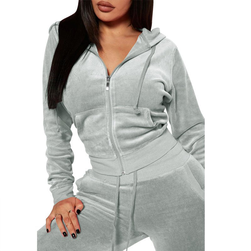 Woman wearing light gray velour zip-up hoodie and matching drawstring pants casual loungewear set