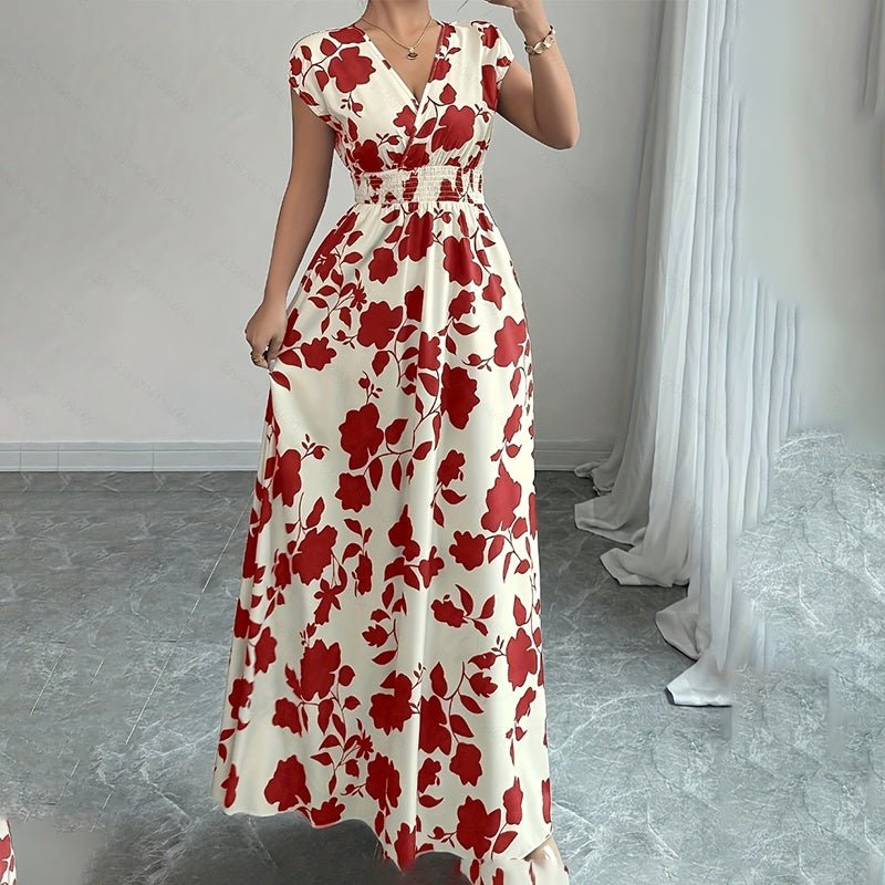 Woman wearing elegant white maxi dress with red floral print, V-neck, short sleeves, and elastic waist in minimalist room