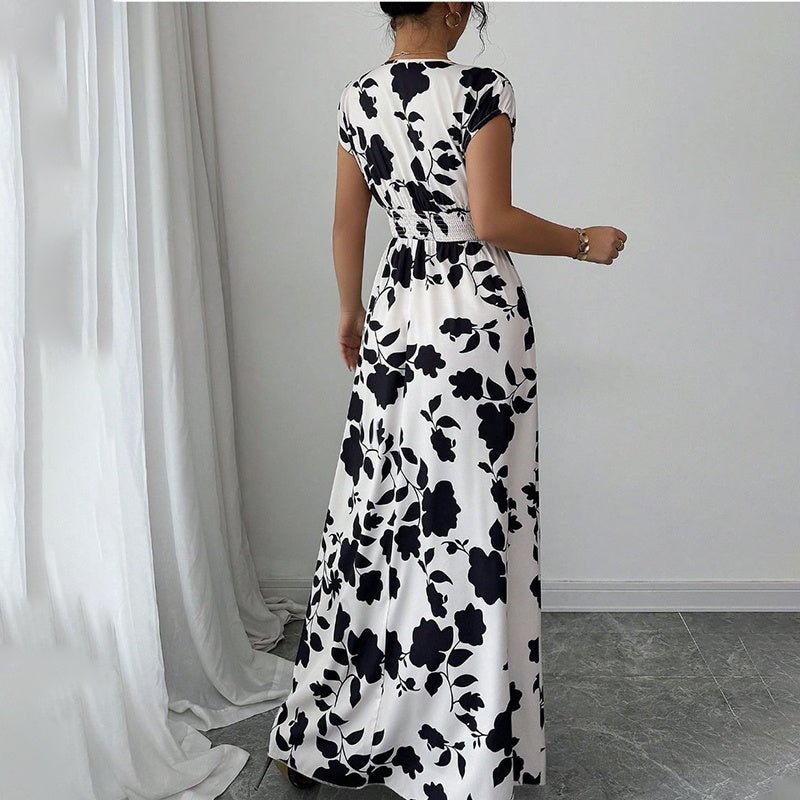 Woman wearing black and white floral maxi dress with elastic waist in modern minimal room
