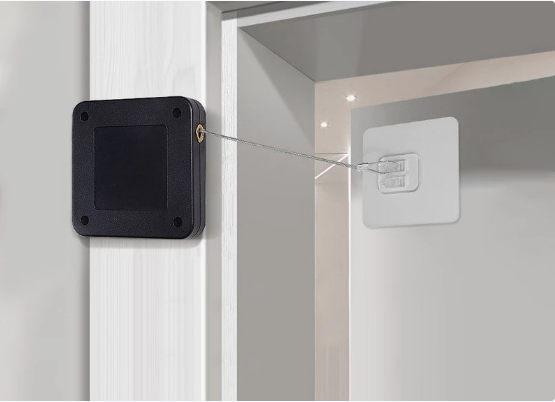 Retractable door security latch installed on white door and frame for enhanced home safety