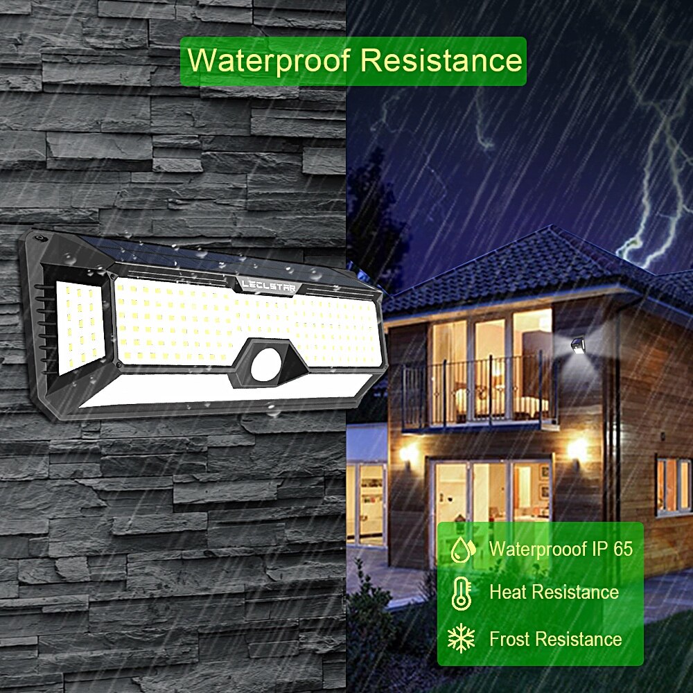 Outdoor LED security light mounted on stone wall with rain, home exterior illuminated in storm